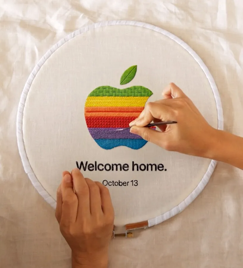 Вышивка логотипа Apple на пяльцах с надписью Welcome home, October 13